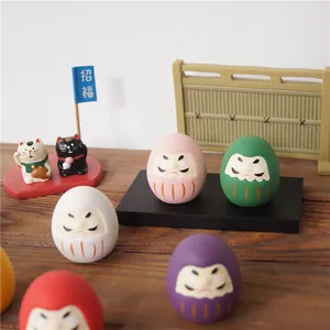 Détails d'ensemble de poupées Daruma japonaises avec chats Maneki Neko sur bureau en bois
