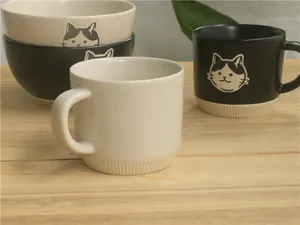 Detail of Japanese ceramic mug and bowl set with cute cat illustration and ribbed texture