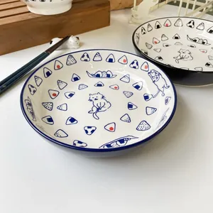 Japanese ceramic cat sushi plate with blue onigiri pattern and wooden display stand