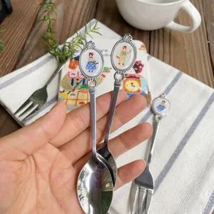 Vintage silver spoon with a watercolor cat illustration on a porcelain handle insert