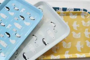 Close-up of cute penguin and polar bear patterned trays in pastel Nordic style