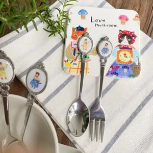 Vintage watercolor cat illustration stainless steel dessert spoon and fork set on table
