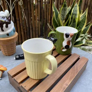 Detail of creative ceramic mugs with 3D cat decorations and vertical relief textures