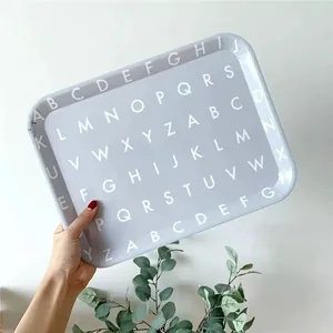 Modern lilac rectangular tray with white alphabet pattern shown in a lifestyle setting