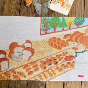 Close-up of heat-resistant placemat with cute cartoon bread character and woven texture