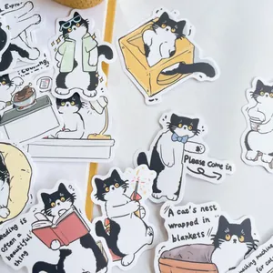 Close-up of cute black and white tuxedo cat stickers with creative DIY diary designs
