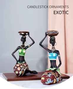 Detailed close-up of exotic resin African tribal women candle holders with hand-painted patterns