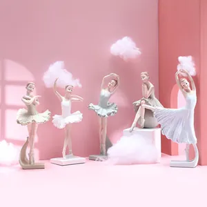 Set of five elegant ballet girl figurines in various poses on geometric stands