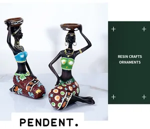 Artistic detail of resin African female figurines featuring colorful elephant pattern gowns