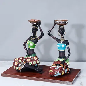 Set of two vintage African style resin female figurines with tribal candle holders