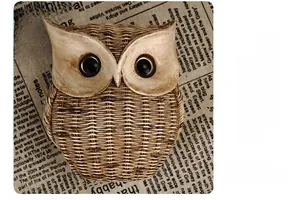 Macro detail of owl figurine featuring woven texture and metallic eyes on vintage backdrop