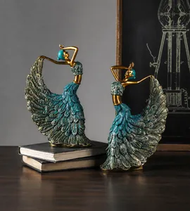 Detail of artistic resin peacock dancers with intricate golden and teal textures
