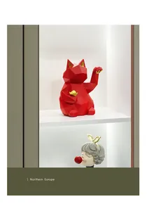 Macro detail of geometric Lucky Cat resin statue with red finish and gold coins