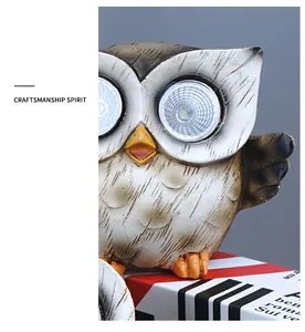 Close-up of solar owl garden light with large LED eyes and detailed resin texture