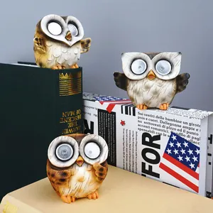 Solar powered owl garden lights set of three with glowing LED eyes and resin wood texture