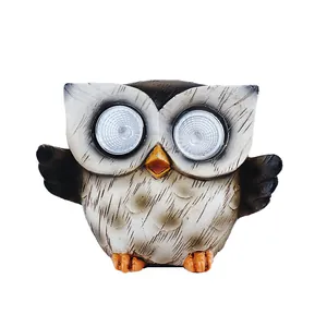 Solar powered owl garden statue with LED eyes crafted from durable resin with stone finish