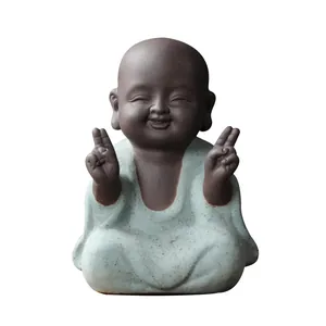 Purple clay monk figurine with blue glaze and cheerful expression for tea tray decoration