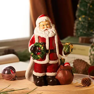 Statuetta di Babbo Natale in resina con sacco regalo e ghirlanda per decorazione da tavolo