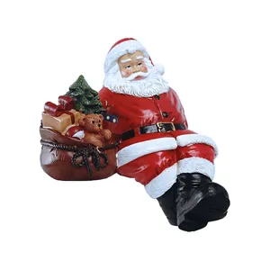 Classic Santa Claus figurine with a brown gift bag and miniature Christmas tree