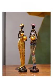 Detail of African woman resin figurines with gold accents and ethnic geometric patterns