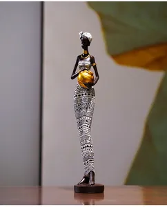 Detailed craftsmanship of African tribal resin statue with golden neck rings and vase