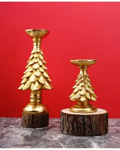 Detail of golden Christmas tree candle holders with metallic leaf texture and wood base