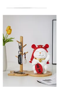 Detail of wooden storage tray with lucky cat figurine for entryway keys and jewelry
