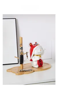 Detail of wooden key organizer with resin rabbit figurine on a desktop storage tray