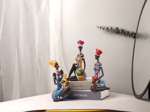 Detailed view of three resin African tribal women figurines in colorful ethnic attire