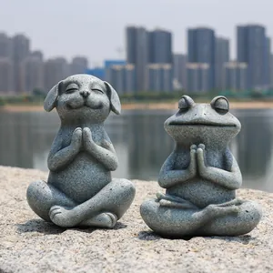 Detailed view of stone texture resin dog and frog figurines in zen meditation poses