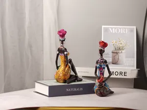 Detail of handcrafted African tribal resin figurines with colorful ethnic attire