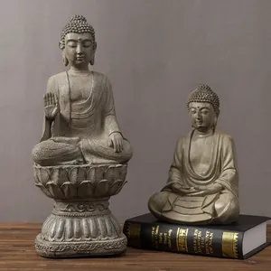 Detailed comparison of two Zen Buddha statues with lotus base in a stone-like finish