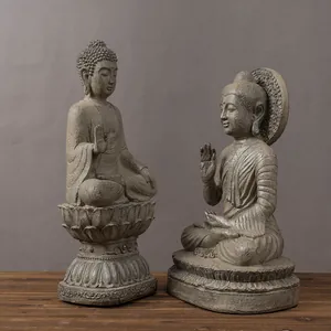 Close-up of weathered resin Buddha statues with lotus base and Zen halo detail