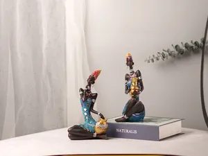 Detailed close-up of African woman resin figurines with intricate handcrafted ethnic attire