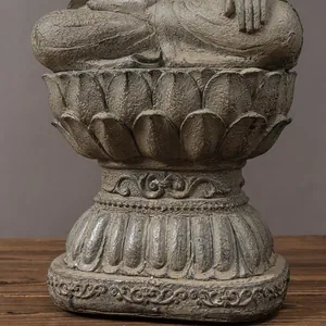 Detailed close-up of an intricate lotus base on a Zen resin Buddha statue with stone texture
