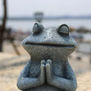 Macro shot of stone-textured meditating frog statue showing detailed resin craftsmanship