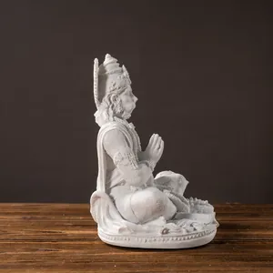 Macro side view of white resin Hanuman deity statue with intricate lotus base carving