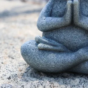 Macro shot of stone texture on meditating yoga frog resin statue for garden decor