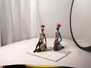 Exquisite African resin figurines with vibrant traditional outfits and sparkling detail