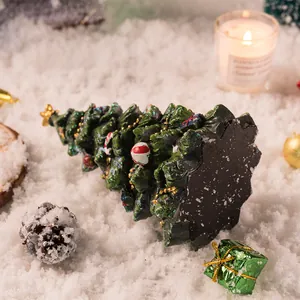 Detailopname van een hars mini kerstboom met gouden ster en feestelijke versiering