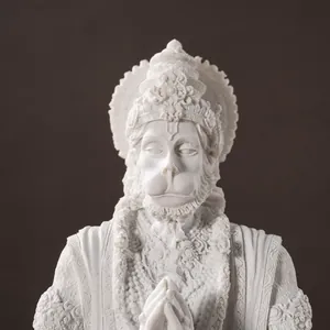 Detailed close-up of white resin Hanuman statue with intricate carvings in prayer pose