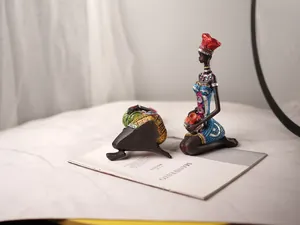 Detail of handcrafted African resin statues with vibrant painting and glitter accents