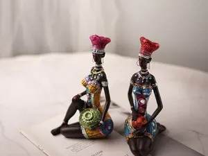 Close-up of African resin sculptures featuring colorful headdresses and detailed textures