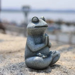 Macro detail of meditating resin frog statue with stone texture for garden Zen decor