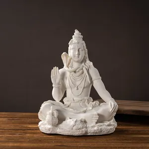 Close-up of white resin Lord Shiva statue in meditation with intricate carved details