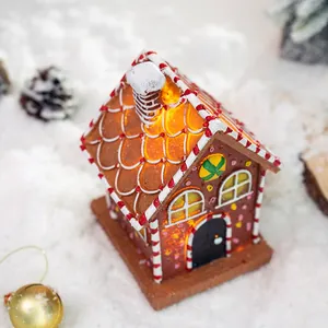 Lighted Christmas gingerbread house ornament with LED glow and festive candy roof decor