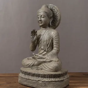 Detail of Buddha statue with antique stone texture showing Abhaya Mudra and halo
