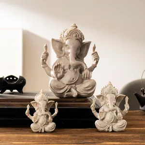 Three-piece sandstone Ganesha statue set in traditional seated pose for home decor
