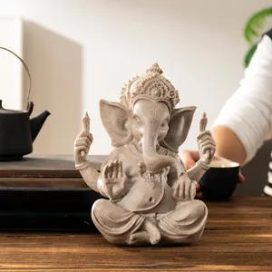 Macro detail of sandstone Ganesha statue showing intricate carvings and matte texture finish