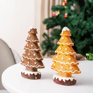 Detailed macro view of resin gingerbread Christmas tree ornaments with snow texture effect